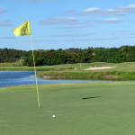 Panoramic view of a lush green golf course at Misty Creek Country Club. Smooth