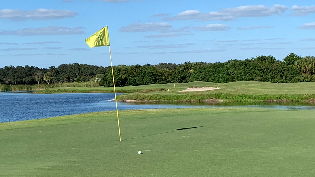 Panoramic view of a lush green golf course at Misty Creek Country Club. Smooth