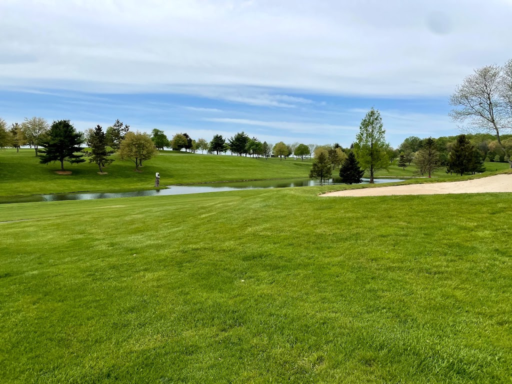 Panoramic view of a lush green golf course at Moccasin Run Golf Club. Smooth