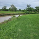 Panoramic view of a lush green golf course at Mohawk Park Golf Course. Smooth