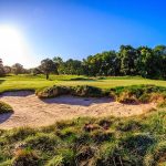 Panoramic view of a lush green golf course at Mohegan Sun Golf Club. Smooth