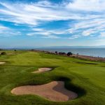 Panoramic view of a lush green golf course at Monarch Bay Golf Club. Smooth