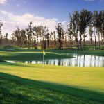 Panoramic view of a lush green golf course at Monarch Dunes Golf Club. Smooth
