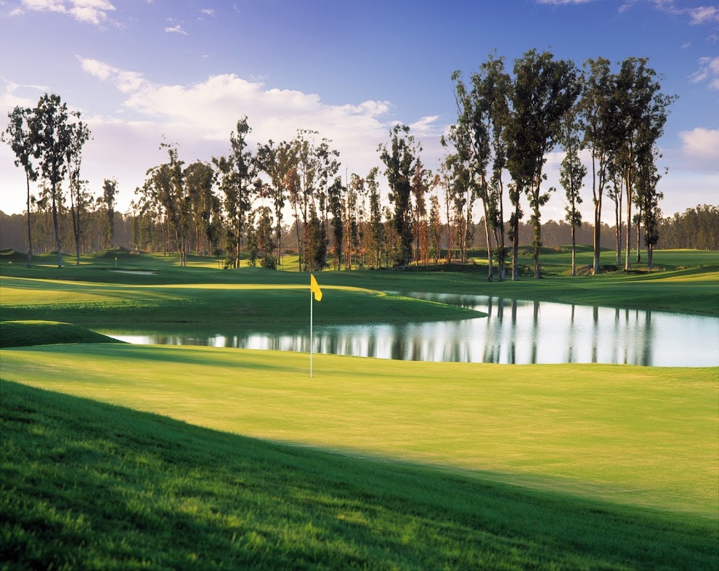 Panoramic view of a lush green golf course at Monarch Dunes Golf Club. Smooth