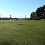 Panoramic view of a lush green golf course at Montaup Country Club. Smooth