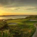 Panoramic view of a lush green golf course at Moody Gardens Golf Course. Smooth