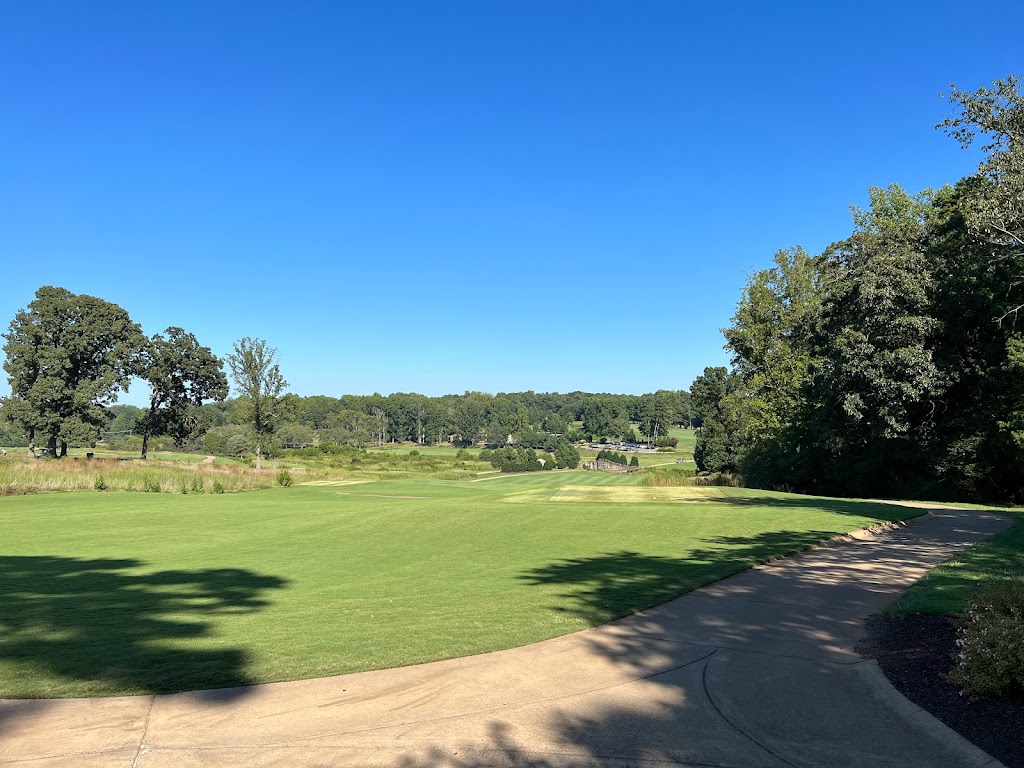 Panoramic view of a lush green golf course at Mooresville Golf Course. Smooth