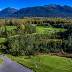 Panoramic view of a lush green golf course at Moose Run Golf Course. Smooth