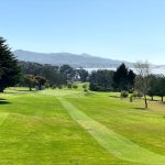 Panoramic view of a lush green golf course at Morro Bay Golf Course. Smooth
