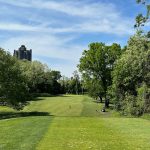 Panoramic view of a lush green golf course at Mosholu Golf Course. Smooth