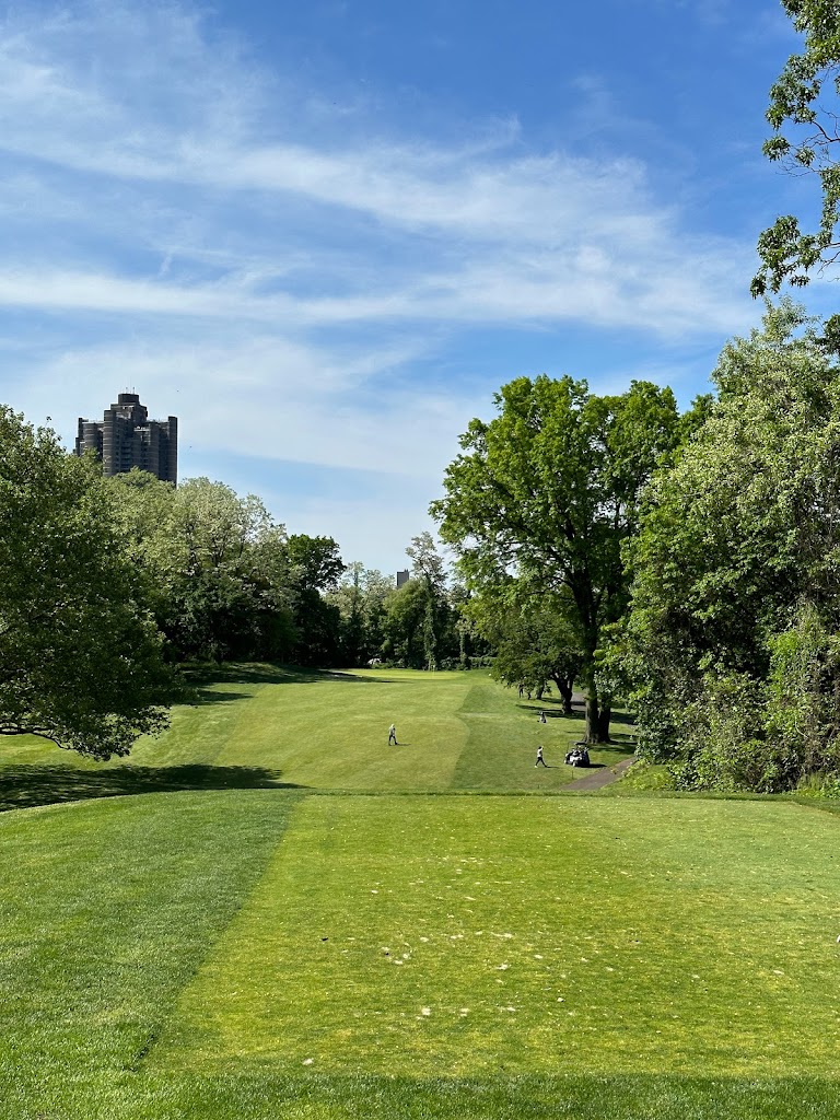 Panoramic view of a lush green golf course at Mosholu Golf Course. Smooth