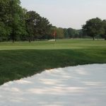 Panoramic view of a lush green golf course at Mount Pleasant Golf Course. Smooth