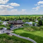 Panoramic view of a lush green golf course at Mountain Branch. Smooth