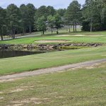 Panoramic view of a lush green golf course at Mountain Ranch Golf Club. Smooth