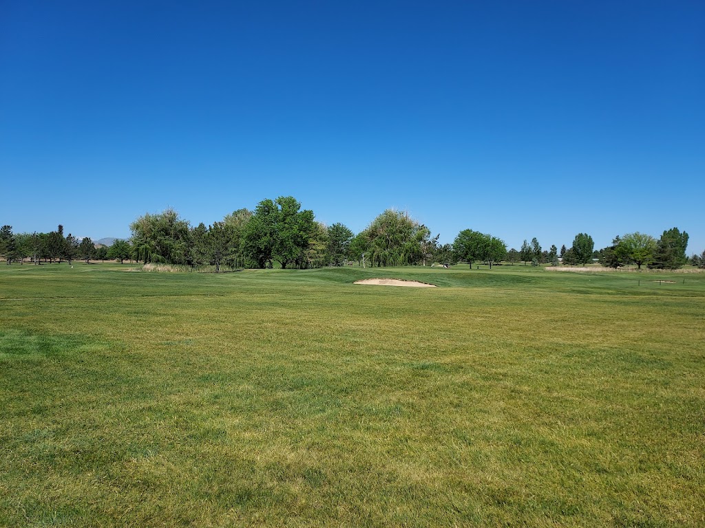 Panoramic view of a lush green golf course at Mountain Vista Greens Golf. Smooth