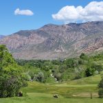 Panoramic view of a lush green golf course at Mt. Ogden Golf Course. Smooth