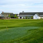 Panoramic view of a lush green golf course at Murphy Creek Golf Course. Smooth
