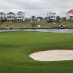 Panoramic view of a lush green golf course at Myrtlewood Golf Club. Smooth