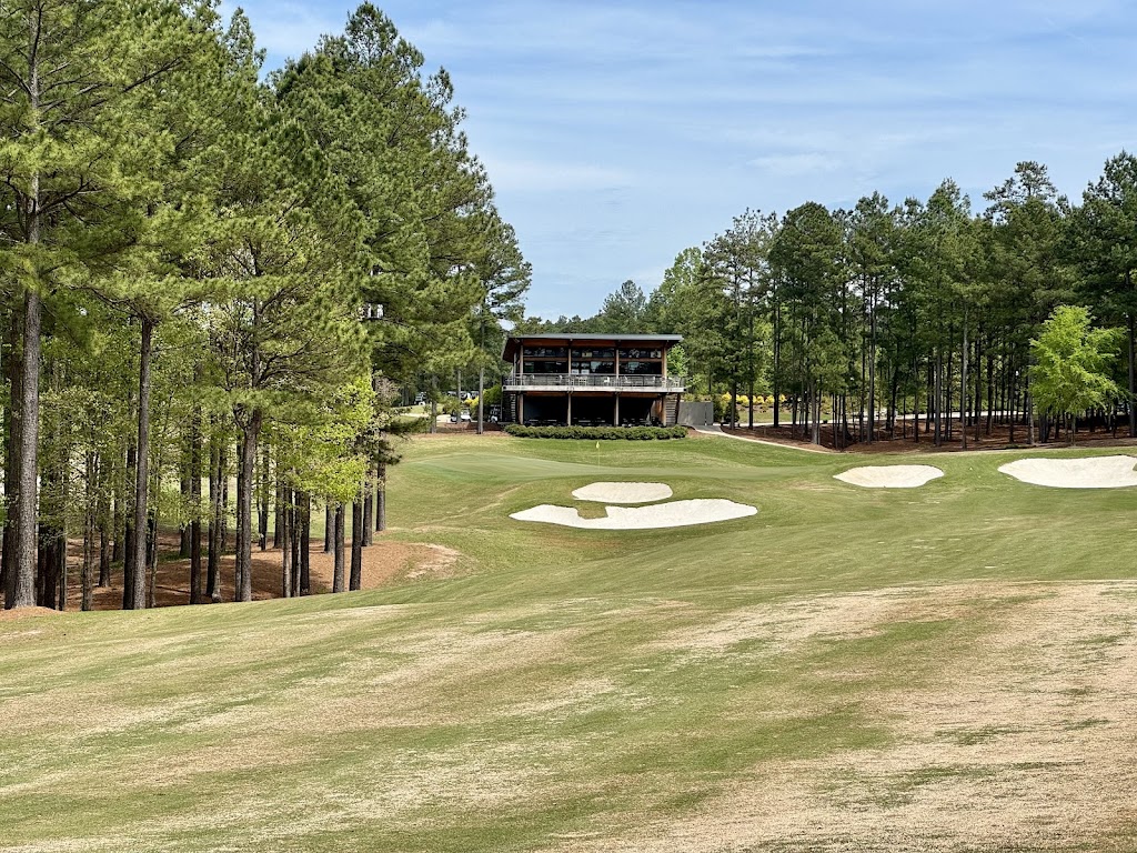 Panoramic view of a lush green golf course at Mystic Creek Golf Club. Smooth