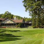Panoramic view of a lush green golf course at Nakoma Golf Club. Smooth