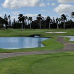Panoramic view of a lush green golf course at Navy Marine Golf Course. Smooth
