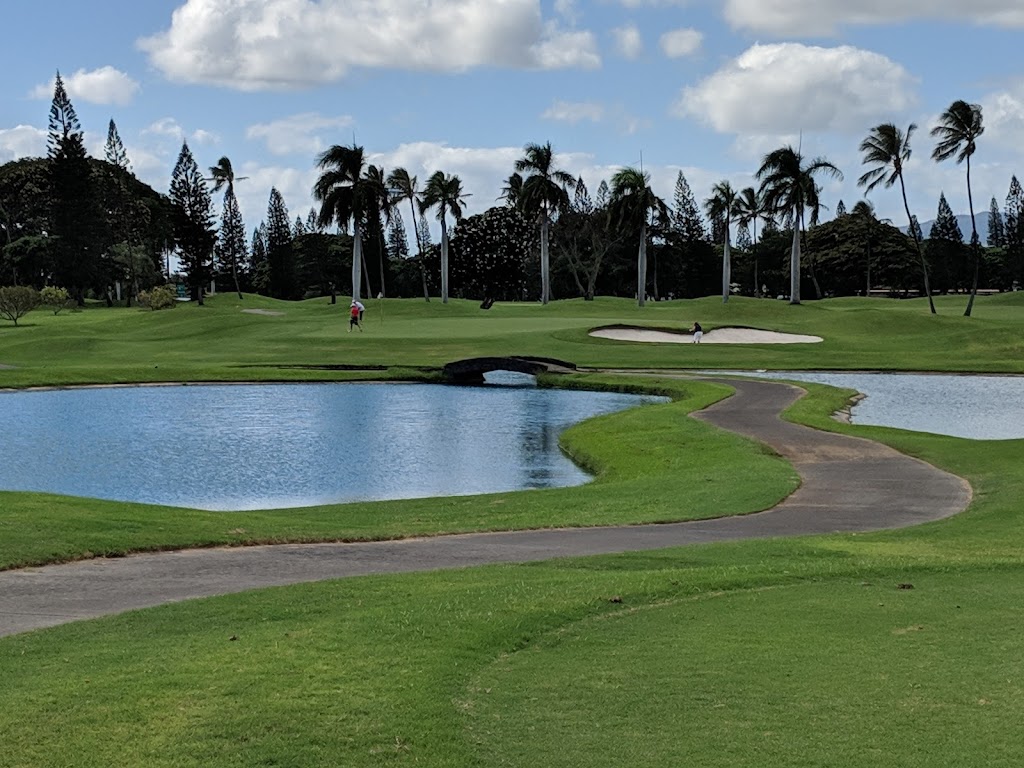 Panoramic view of a lush green golf course at Navy Marine Golf Course. Smooth
