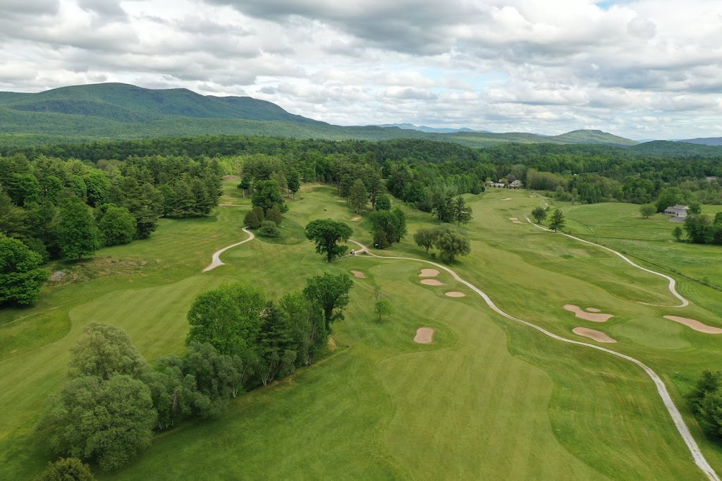 Panoramic view of a lush green golf course at Neshobe Golf Club. Smooth