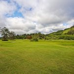 Panoramic view of a lush green golf course at Neskowin Beach Golf Course. Smooth