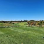 Panoramic view of a lush green golf course at Nevel Meade Golf Course. Smooth