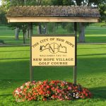 Panoramic view of a lush green golf course at New Hope Village Golf Course. Smooth