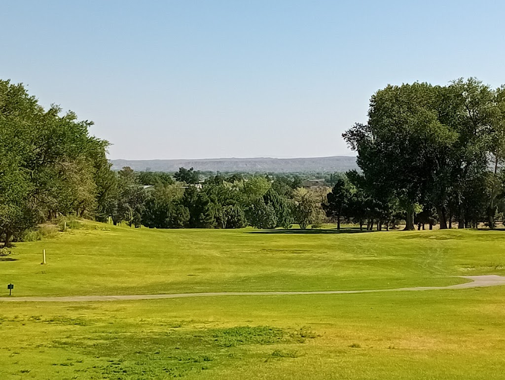 Panoramic view of a lush green golf course at New Mexico Tech Golf Course. Smooth