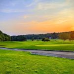 Panoramic view of a lush green golf course at Nob North Golf Course. Smooth