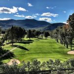 Panoramic view of a lush green golf course at North Conway Golf Course. Smooth