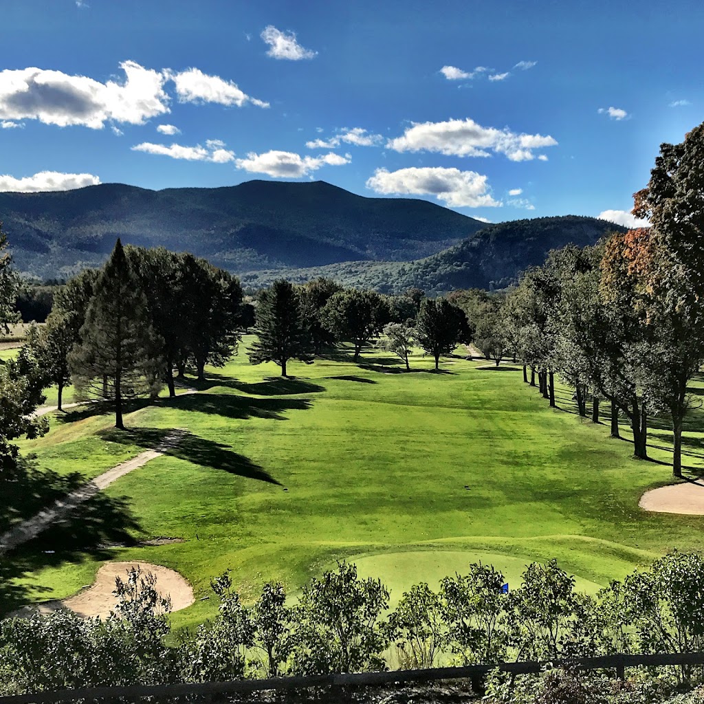 Panoramic view of a lush green golf course at North Conway Golf Course. Smooth