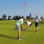 green grass with the flag in the hole.