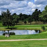 Panoramic view of a lush green golf course at North Kent Golf Course Inc.. Smooth