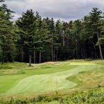 Panoramic view of a lush green golf course at Northeast Harbor Golf Club. Smooth