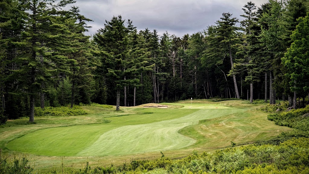Panoramic view of a lush green golf course at Northeast Harbor Golf Club. Smooth