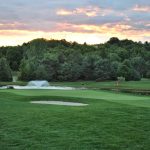 green grass with the flag in the hole.