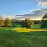Panoramic view of a lush green golf course at Northport Golf Club. Smooth