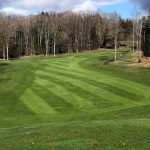 Panoramic view of a lush green golf course at Northwinds Peninsula Golf Club. Smooth