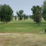Panoramic view of a lush green golf course at Northwood Golf Course. Smooth
