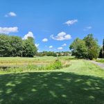Panoramic view of a lush green golf course at Norton Country Club. Smooth