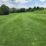 Panoramic view of a lush green golf course at Norvelt Golf Club. Smooth