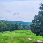 Panoramic view of a lush green golf course at Norwich Golf Club. Smooth