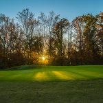 Panoramic view of a lush green golf course at Oak Creek Golf Club. Smooth