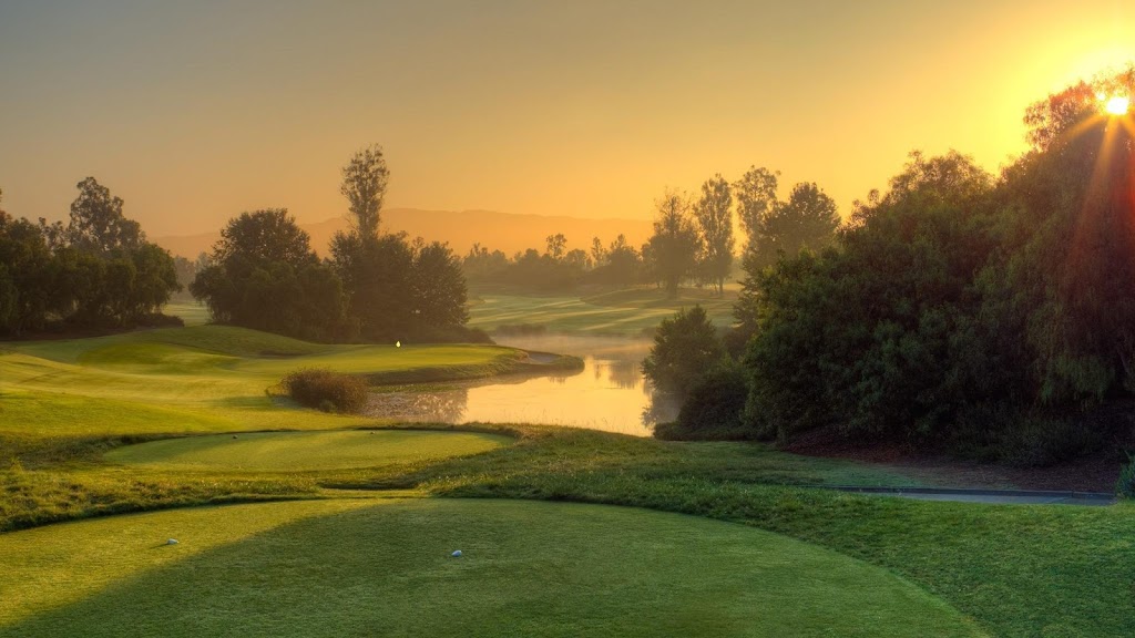 Panoramic view of a lush green golf course at Oak Creek Golf Club and Driving Range. Smooth