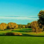 Panoramic view of a lush green golf course at Oak Glen Golf Course and Event Center. Smooth