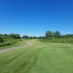 Panoramic view of a lush green golf course at Oak Grove Golf Course. Smooth