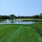 green grass with the flag in the hole.